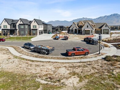 View of asphalt road featuring a residential view, sidewalks, a mountain view, and curbs