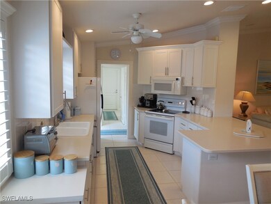 Kitchen with white appliances, white cabinets, kit