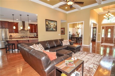Open concept floor plan with gleaming hardwood floors.