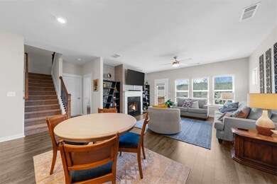 Dining space featuring wood finished floors, stair