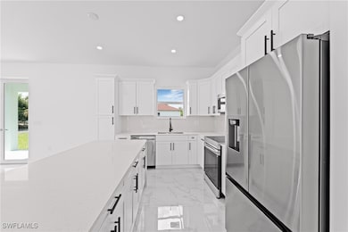 Kitchen with appliances with stainless steel finis