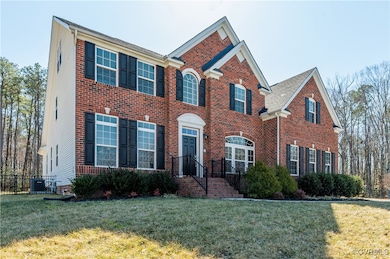 View of front facade with brick siding, central AC