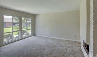 Living room with big picture windows, fireplace an