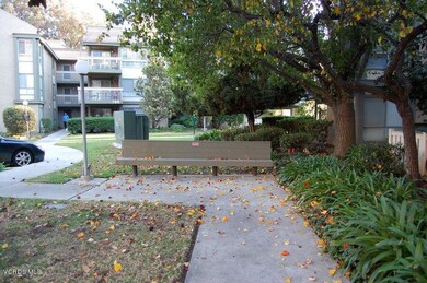 Pretty lanscaping and Bench outside 801