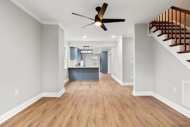 Unfurnished living room featuring crown molding, s