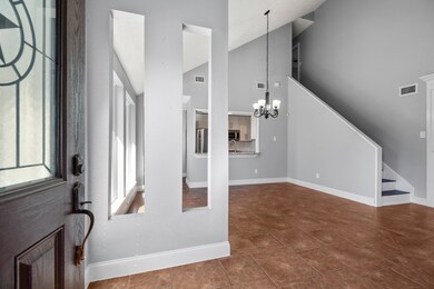 Inviting entryway featuring tile flooring and neutral tones that lead seamlessly into the dining area—offering a warm and welcoming first impression of the home.