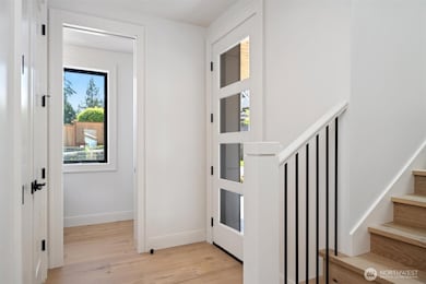 Well-lit entrance with glass paneled front door