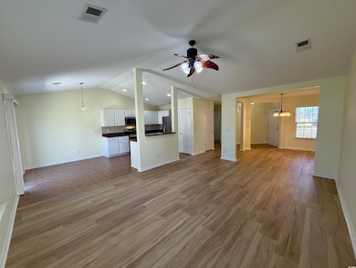 Unfurnished living room featuring a chandelier, dark wood-style flooring, a ceiling fan, vaulted ceiling, and recessed lighting