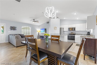 Tiled dining room with sink, ceiling fan with nota