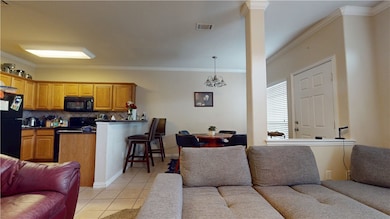 Living room with light tile patterned floors, orna
