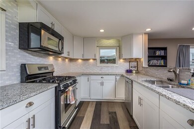 The kitchen features granite counter tops with bac