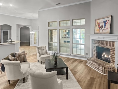 Living room with a chandelier, ornamental molding,