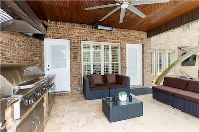 View of patio with an outdoor living space, a ceiling fan, and an outdoor kitchen