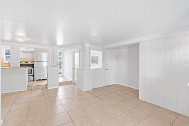 Unfurnished living room featuring light tile patt