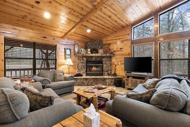 Living room featuring high vaulted ceiling, wooden