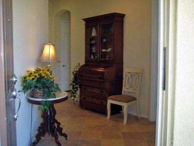 A welcome and inviting entry.  The home has been upgraded with tile extending along high traffic areas