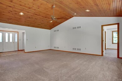 Living room with wooden cathedral ceiling