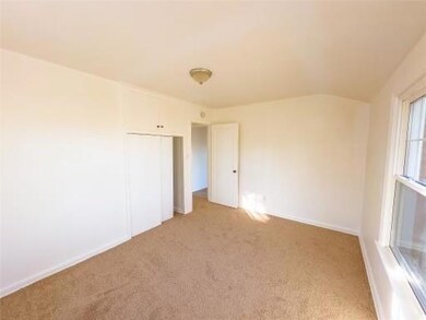 Unfurnished bedroom with a closet and light colored carpet