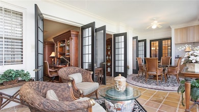 Living area featuring french doors, tile patterned