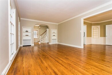 Sunny Living Room features Built-in's, Crown Moldi