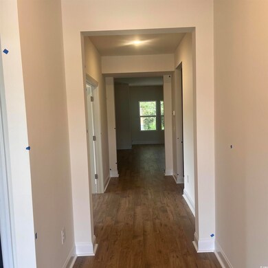 Hallway with dark wood finished floors