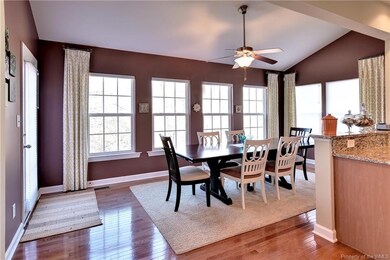 The light filled morning room with vaulted ceiling overlooks the backyard.