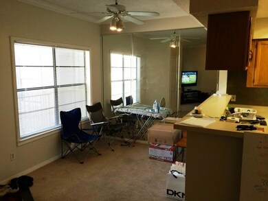 Office area with light carpet and ceiling fan