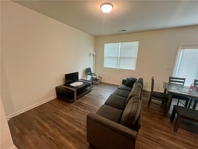 Living room featuring dark wood finished floors and healthy amount of natural light