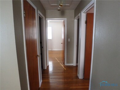Hallway with hardwood floors and fresh paint