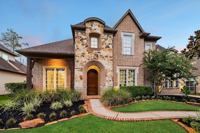 The impressive exterior showcases brick and flagstone accents complemented by elegant cast stone window trims and refined architectural details. This home has been meticulously maintained inside and out, with major upgrades including a new roof (2020), new HVAC units (downstairs 2022, upstairs 2023), and new garage doors (2020).