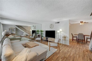 Living area with light wood-style floors, a textur