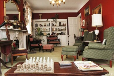 The parlor is spacious, warm and inviting with ple