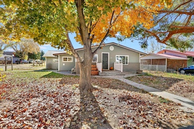 Bungalow-style home featuring a patio area, a metal roof, and brick siding