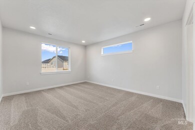 Unfurnished room with light colored carpet and recessed lighting