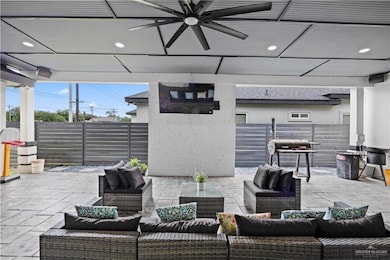 Fenced backyard featuring an outdoor hangout area, a ceiling fan, and a patio area