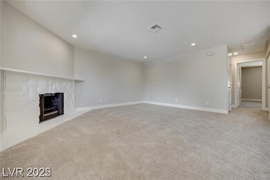 Unfurnished living room featuring light carpet, re