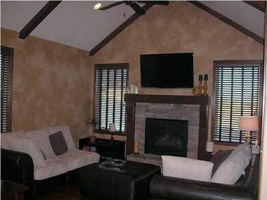 Warm and inviting hearth room features beamed, vau