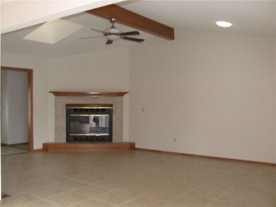 Ceramic tile in entry, living  room, kitchen and dinning room.  Gas log fire place with exposed beam and sky lights.