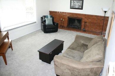 Spacious Formal Living Room With a Custom Brick Fi