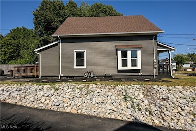 View of property exterior with a shingled roof