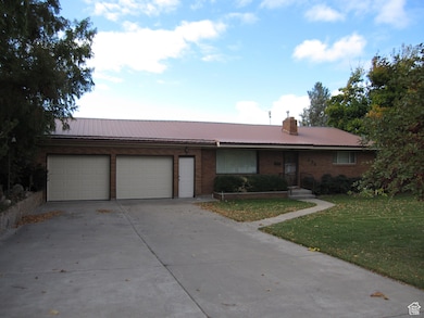 Ranch-style home with a garage and a front lawn