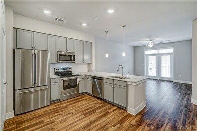 Kitchen has vinyl plank floors, stainless steel ap