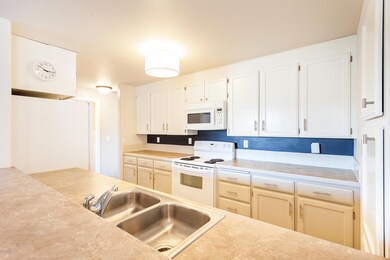 Kitchen w/ white & grey cabinetry