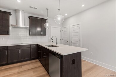 Kitchen with wall chimney exhaust hood, light hard