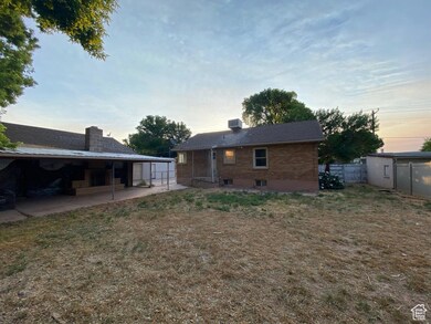 Rear view of property with a chimney and a patio area