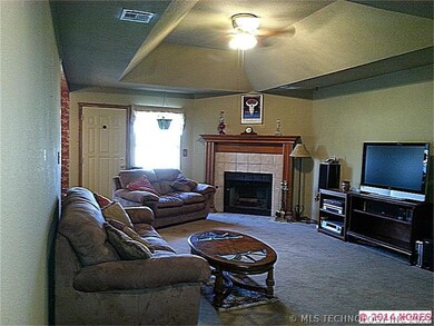 Foyer view of large living room with treyed ceilin
