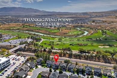 Aerial view of property's location with a mountainous background, nearby suburban area, and a golf course
