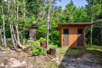 View of outdoor structure with a wooded view