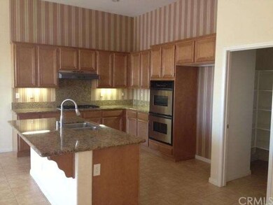 Kitchen with double ovens, granite counter tops & 