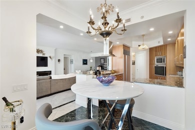 Dining space with light marble finish floors, orna